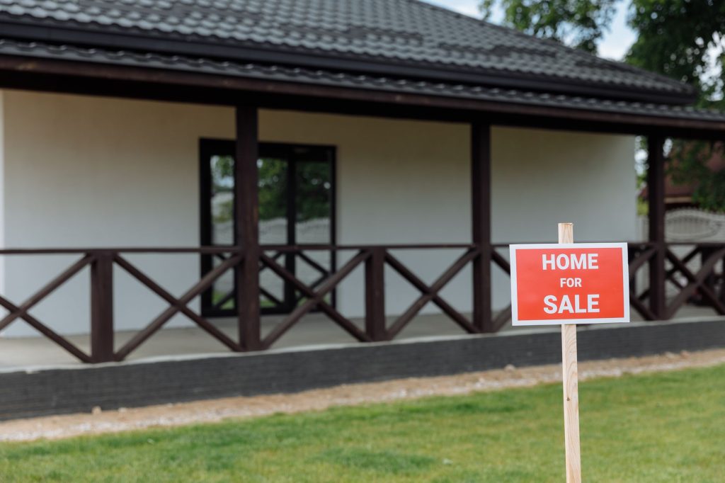 First-time homebuyer reviewing listings, mortgage options, and neighborhood amenities before purchasing a house.